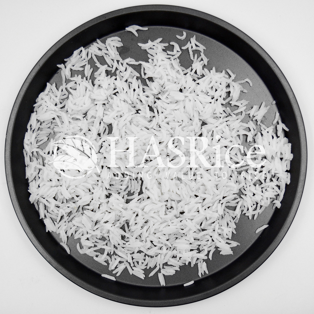 Cooked 1121 Basmati White rice on a dark plate showing separated, elongated grains